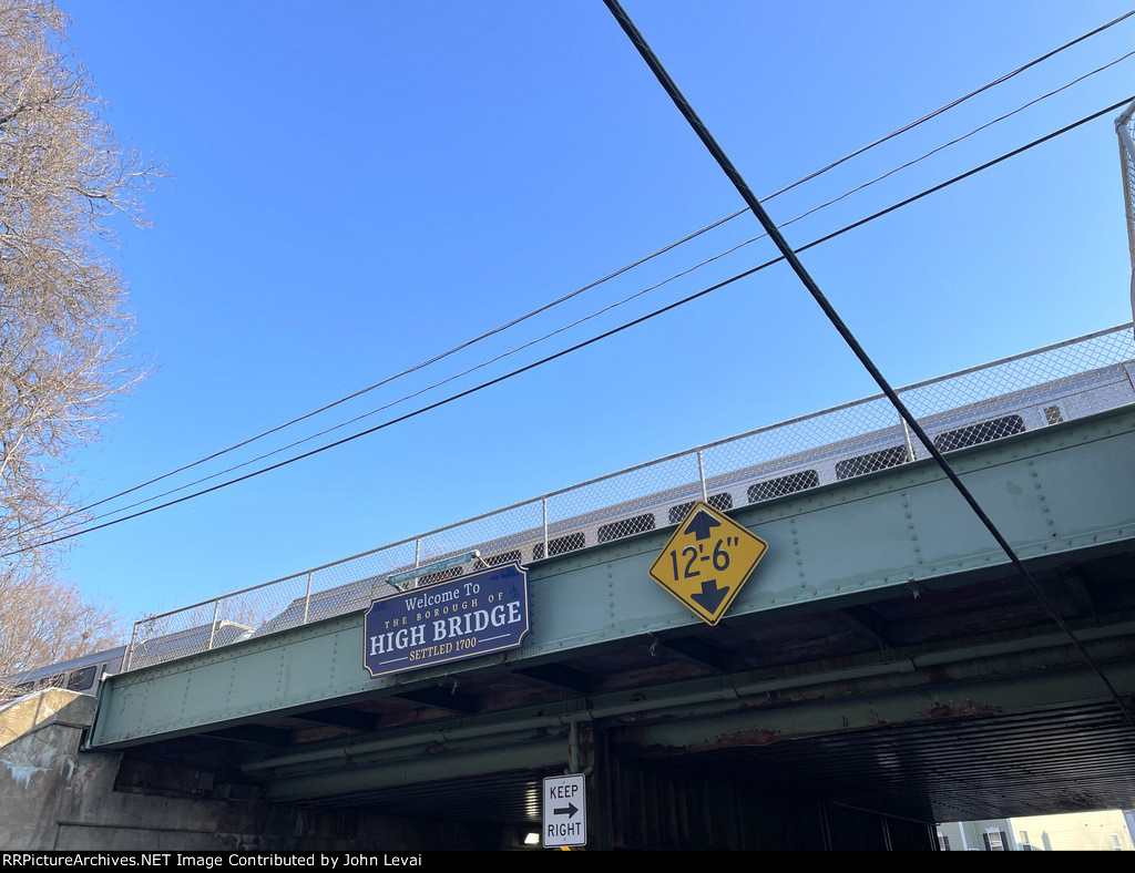 A "Welcome to High Bridge" sign sitting on the NJT trestle over Bridge St in High Bridge